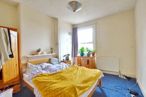 Spacious double bedroom featuring a cozy bed wi...
