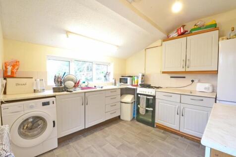 This cozy kitchen features ample storage and co...
