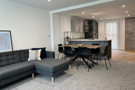 Spacious and modern living room featuring a com...