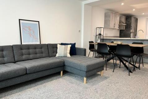 This stylish living room features a modern gray...