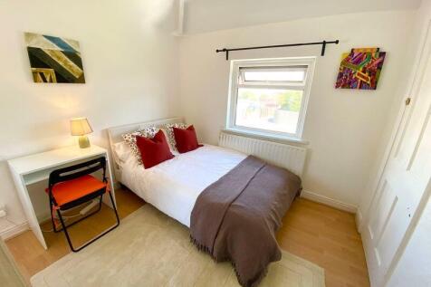 This charming double bedroom features a cozy am...