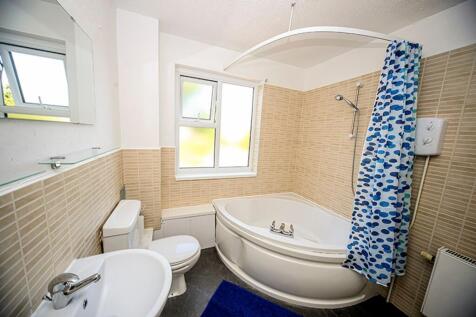 A bright and clean bathroom featuring a stylish...