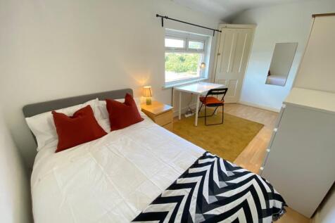 A bright and inviting double bedroom featuring ...