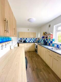 This modern kitchen features a bright and invit...