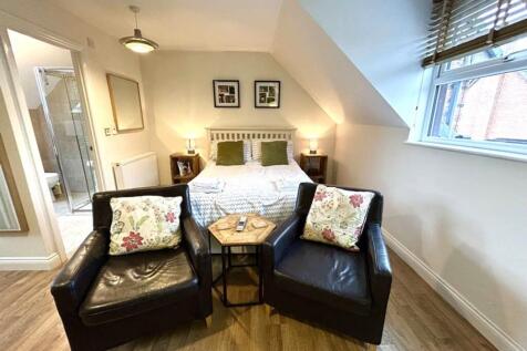 A bright and inviting double bedroom featuring ...
