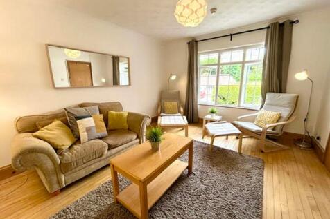A bright and inviting large modern living room,...