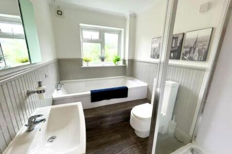 A spacious and well-lit large bathroom featurin...