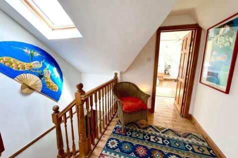 A bright and tidy hallway featuring unique deco...