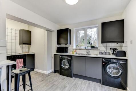 Modern kitchen featuring sleek cabinetry, ample...