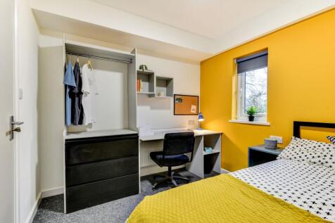 This inviting double bedroom features a cozy be...