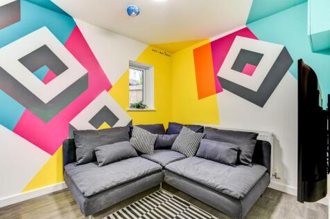 A vibrant living room featuring a spacious and ...