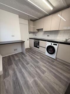 Modern and well-equipped kitchen featuring slee...