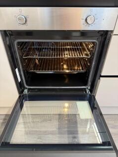 Modern kitchen featuring a sleek oven with ampl...