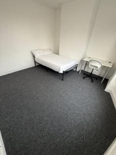 This well-lit double bedroom offers a cozy atmo...