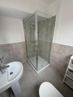 Modern bathroom featuring a sleek glass shower ...