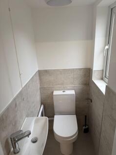 Modern single toilet featuring sleek fixtures a...