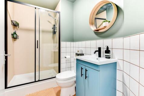 This modern bathroom features a stylish shower ...