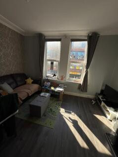 Bright and inviting living room featuring large...