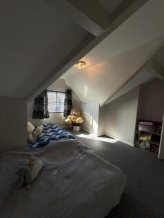 This cozy double bedroom features a comfortable...