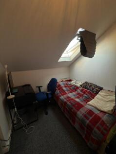 Cozy double bedroom featuring a comfortable bed...