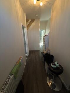 A bright and welcoming hallway featuring modern...