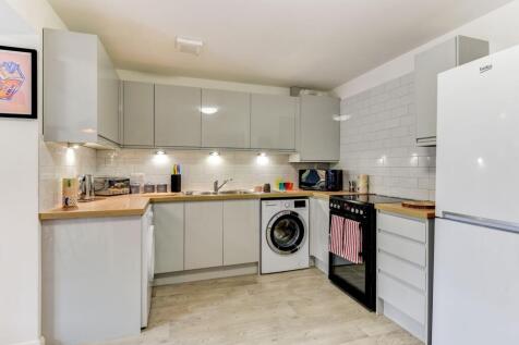 A modern and stylish kitchen featuring sleek ca...