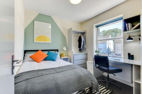 A cozy double bedroom featuring vibrant decor w...