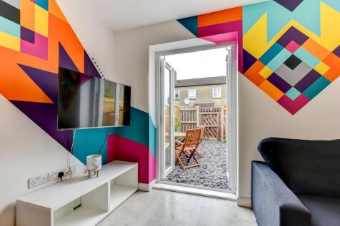 This vibrant living room features a striking wa...