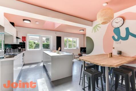 A vibrant and modern kitchen featuring a spacio...