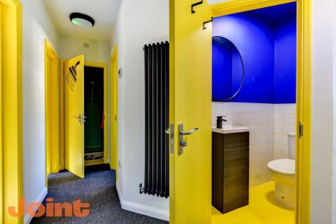 This vibrant bathroom features a modern design ...