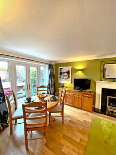This inviting living room features a cozy dinin...
