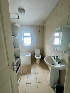 A well-maintained bathroom featuring a bathtub ...