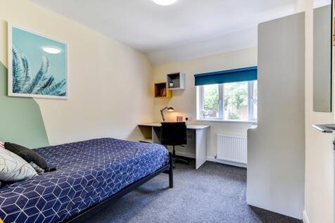 This inviting double bedroom features a cozy la...