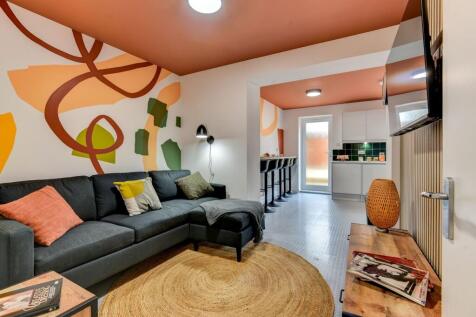 A stylish and vibrant living room featuring a s...