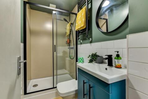 This modern bathroom features a sleek shower, s...