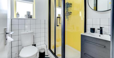A stylish and modern bathroom featuring a sleek...