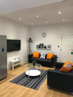 A stylish and inviting living room featuring mo...