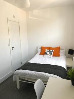 This cozy double bedroom features a comfortable...