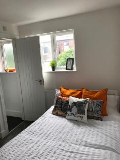 A cozy double bedroom featuring bright decorati...