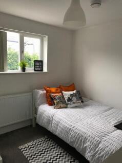 This inviting double bedroom features a cozy at...