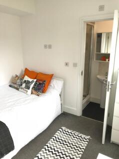 Cozy double bedroom featuring a comfortable bed...
