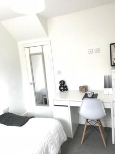 This inviting double bedroom features a cozy be...