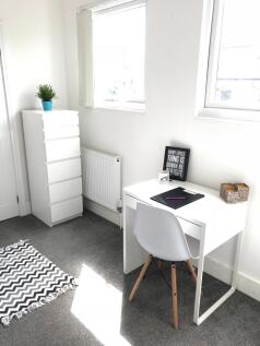 Bright and inviting communal workspace featurin...