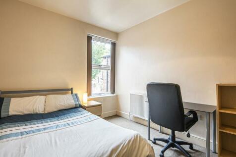This cozy double bedroom features a comfortable...