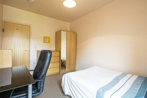 This cozy double bedroom features a comfortable...