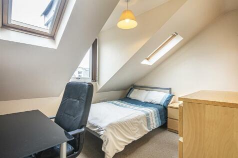 This cozy double bedroom features a comfortable...