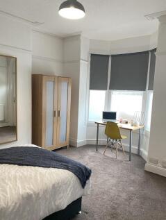 A bright and cozy double bedroom featuring a co...
