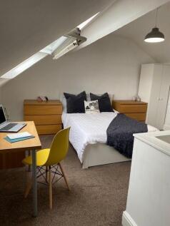 This inviting double bedroom features a cozy la...