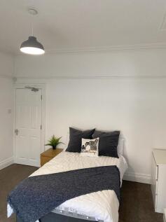 This inviting double bedroom features a cozy la...