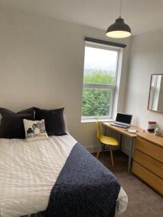 A charming double bedroom featuring a cozy bed,...